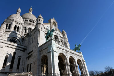 Low angle view of historic building against blue sky