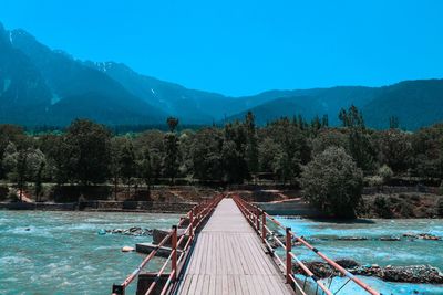 Scenic view of mountains against clear blue sky