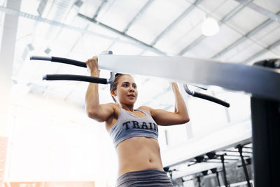 Low angle view of woman exercising at gym