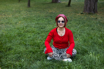 Portrait of young woman standing on field