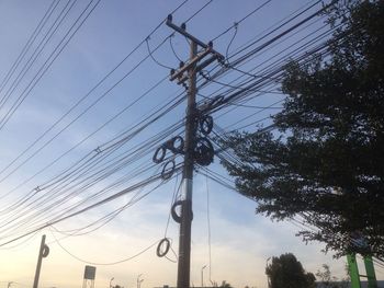 Low angle view of electricity pylon against sky