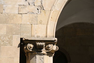 Old sculpture against building