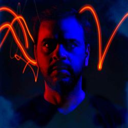 Portrait of man against black background