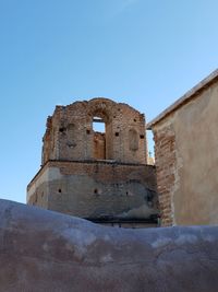 Low angle view of historic building against blue sky