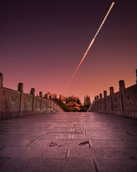 Bridge against sky during lunar eclipse at night