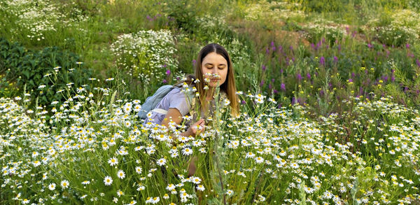 Portrait of a smiling young woman on purple flowering plants