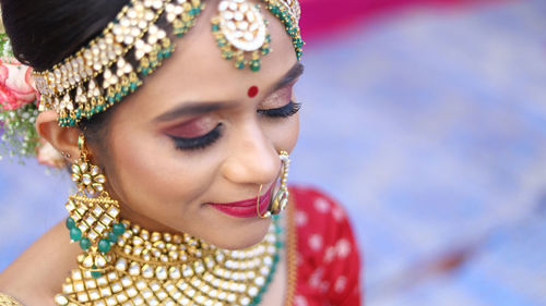 Close-up of beautiful bride with make-up and jewelries