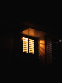 Low angle view of illuminated lamp in building