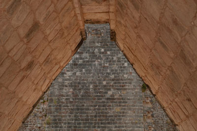 Low angle view of brick wall of building