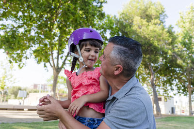 Father and daughter spending time together outdoors in a park.