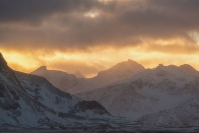 Scenic view of snowcapped mountains against sky during sunset