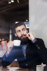 Hipster businessman on break for a coffee