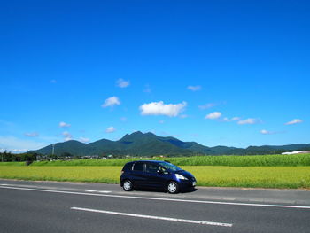 Car on road against blue sky