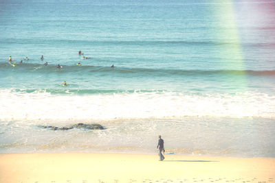 Man standing on beach against sky