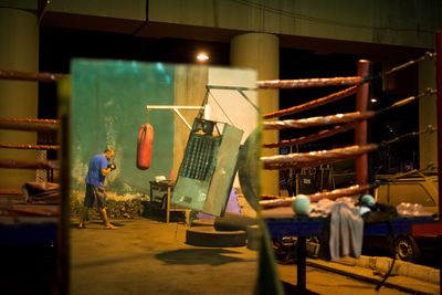 Reflection of boxer with punching bag on mirror