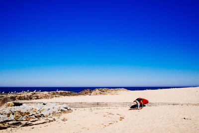 Scenic view of sandy beach against clear sky