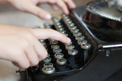 Cropped woman hands using typewriter