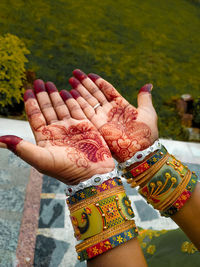 Cropped hand of woman with beautiful bengals or with mehandi.