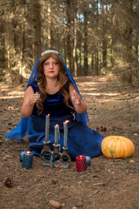 Portrait of young woman sitting on field