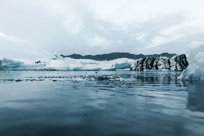 Scenic view of frozen lake against sky
