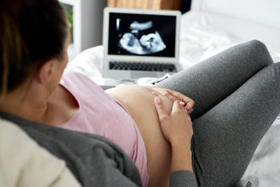 Midsection of woman using mobile phone