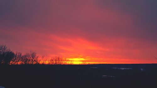 Silhouette landscape against sky during sunset