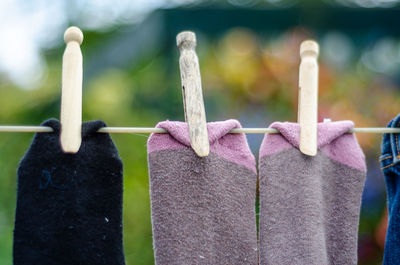 Close-up of clothes hanging on wooden post
