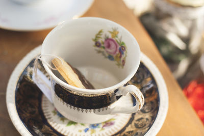 Close-up of teabag in cup on table