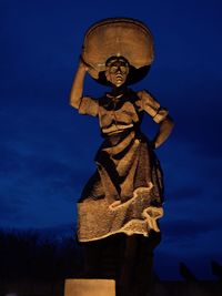 Low angle view of statue against blue sky