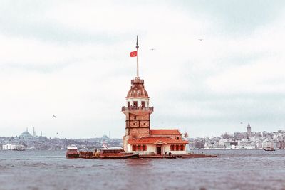 View of building by sea against sky