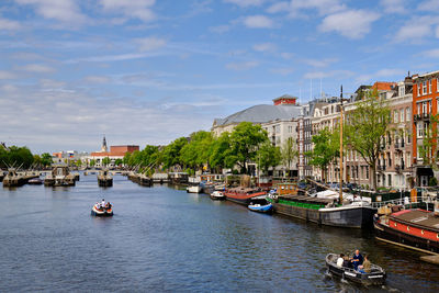 Amsterdam, netherlands. panoramic view along the amstel with passenger boats and the city skyline.
