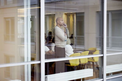 Businessman talking on phone in office