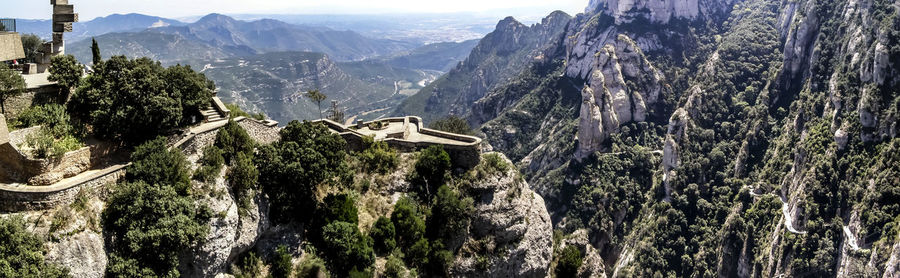 Panoramic view of trees and mountains against sky