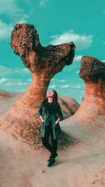 Full length portrait of man standing on rock