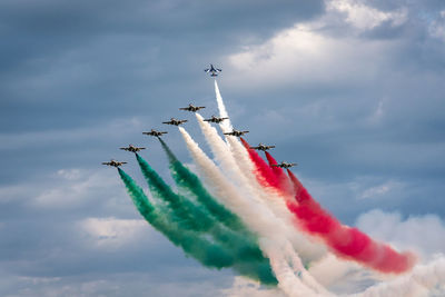 Low angle view of airplane flying against sky