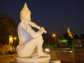 Statue of illuminated building at night