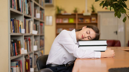 Young woman using laptop at library