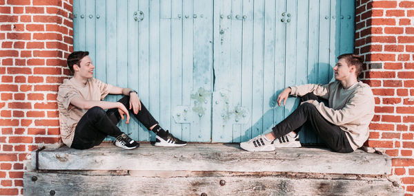 Young couple sitting on wall