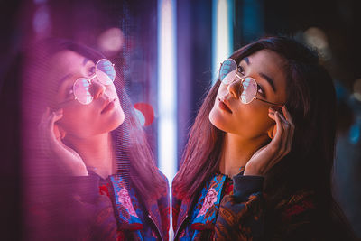 Portrait of woman drinking water