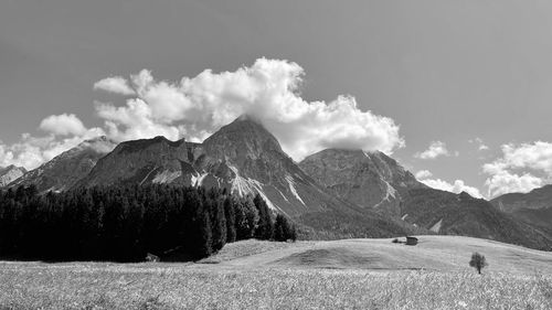 Scenic view of land and mountains against sky