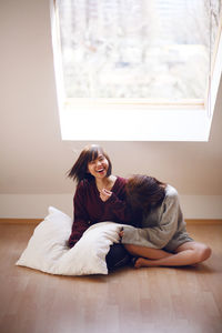 Portrait of young woman sitting at home