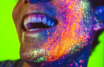 Close-up of man with multi colored face paint