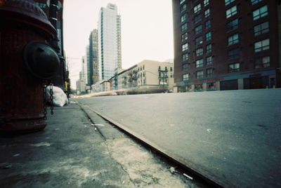 Street amidst buildings against clear sky