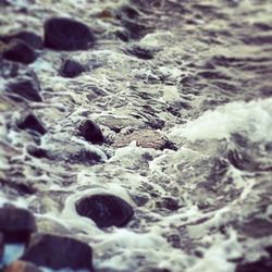 Waves splashing on rocks at beach