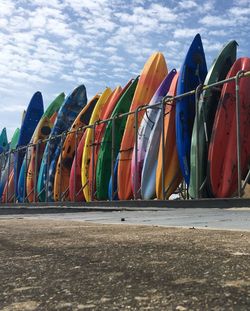 Colorful umbrellas in row against sky