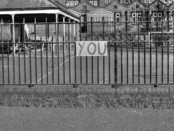 Road sign on fence