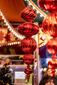 Close-up of illuminated lanterns hanging at market stall