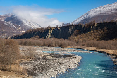 Scenic view of snowcapped mountains against sky. mountain river. 