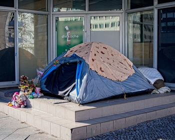 Urban camping tent setup in front of building