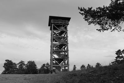 Low angle view of built structure on field against sky